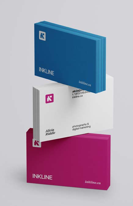 Stacked Inkline business cards in cerulean, magenta and cobalt