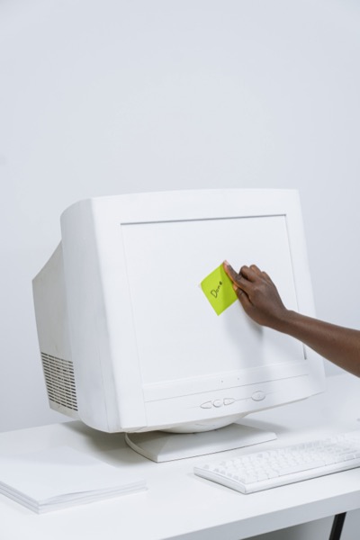 Hand placing done sticky note