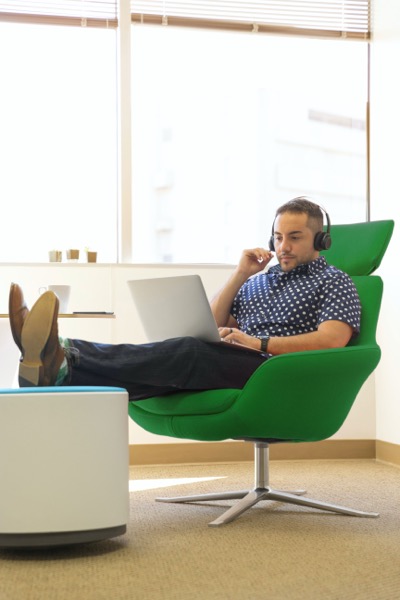 Man in green chair with laptop