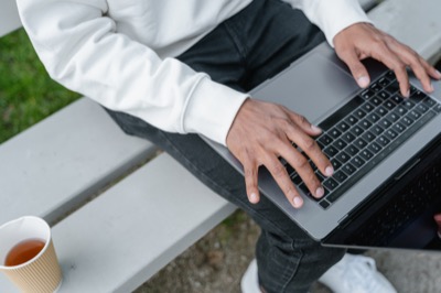 Person working laptop outdoors