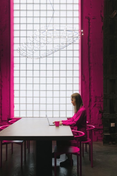 Woman in pink blouse working laptop
