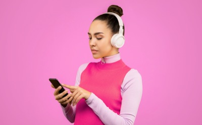 Woman pink outfit white headphones