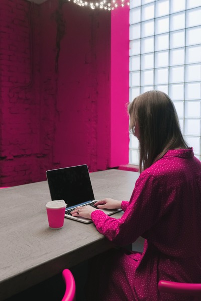 Woman pink polka dot blouse laptop